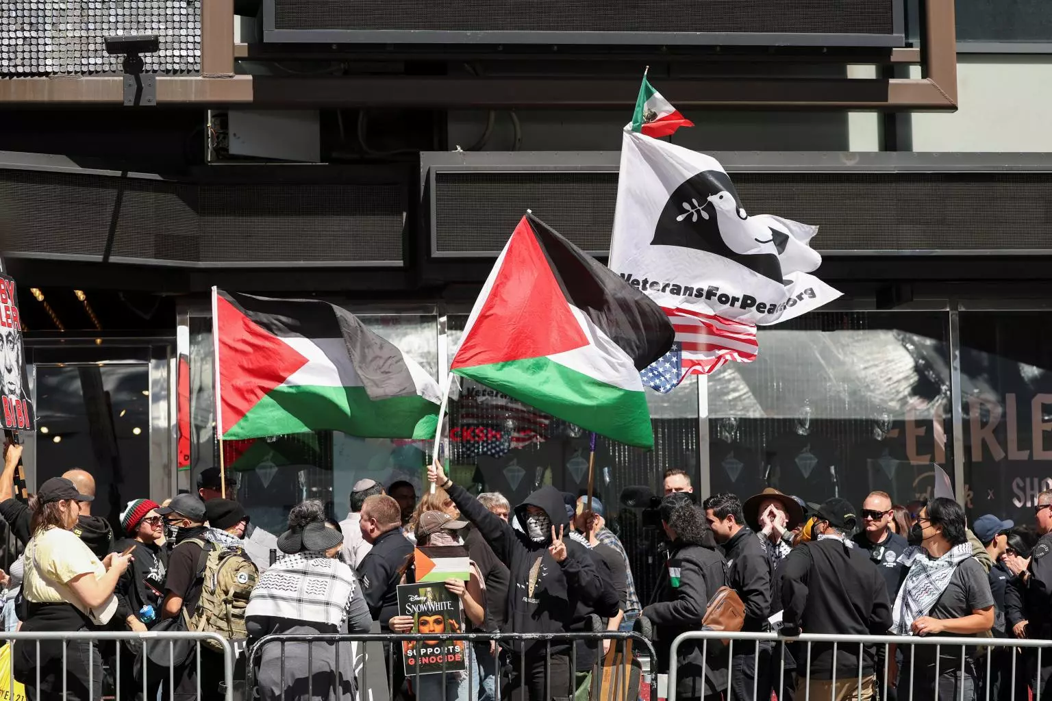 people-hold-palestinian-flags-gather-100685845.webp